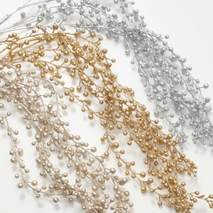 Sparkling artificial berry branches in gold, silver and champagne for Christmas decor