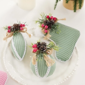 Sage green corduroy Christmas ornaments set with lace trim and festive pine cone details