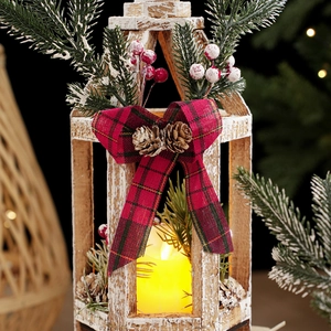 Vintage wooden Christmas lantern with warm LED candle, pine cones and red berries decoration
