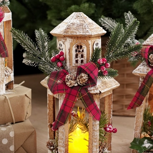 Detail of wooden Christmas lantern with LED candle, pine cones, and red festive bow