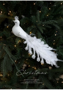 Detail of white feather peacock ornament with silver sequins and lace on Christmas tree