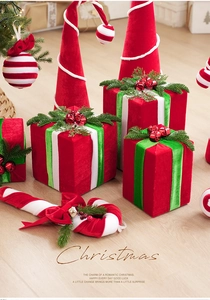 Detail of red velvet Christmas gift box ornaments with green ribbons and festive candy canes