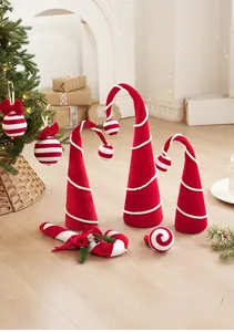 Red velvet Christmas candy cane and plush hat ornaments displayed in a festive scene
