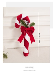 Detail of a 45cm candy cane ornament with red velvet bow and pine needles on white fur