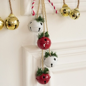 Christmas iron bell set with star cutouts, pine needle decor and hanging twine rope