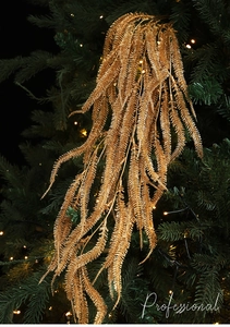 Champagne gold glitter artificial leaves for Christmas tree decoration close-up view
