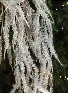 Close-up of artificial silver glitter willow leaf branch for Christmas tree decor