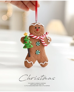 Close-up of clay gingerbread man ornament with scarf and tree for Christmas decor