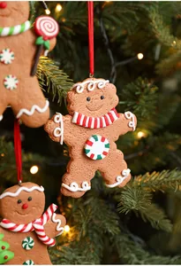 Macro detail of Gingerbread Man Christmas tree ornaments with colorful scarves and candy