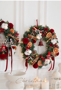 Macro view of Christmas wreath with cotton, orange slices, and warm LED string lights