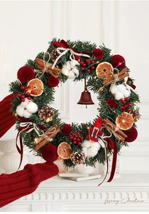 Detail of Christmas wreath with dried orange slices cinnamon sticks and LED warm lights
