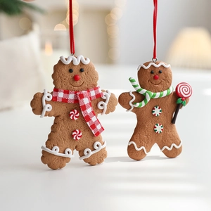 Set of two gingerbread man Christmas tree ornaments with festive scarves and candy details