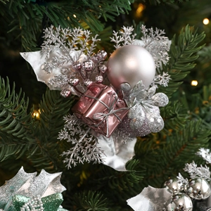 Pink and silver Christmas picks with leaves and gift boxes on tree branches