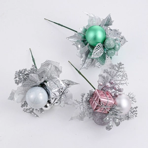 Three assorted Christmas floral picks with white gift boxes and glitter leaves for tree decor