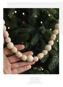 Detailed view of natural wooden beads garland with geometric and smooth round textures