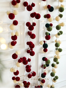 Detail of 1.8M flocked Christmas ball garland with red and green velvet spheres on a rope