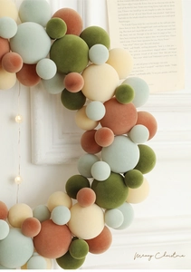 Detailed close-up of colorful velvet ball Christmas wreath with matte flocked texture