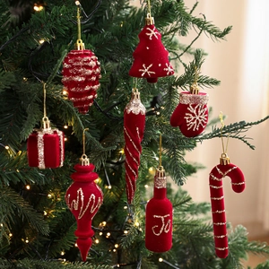 Detailed close-up of red flocked Christmas ornaments with gold glitter on a tree