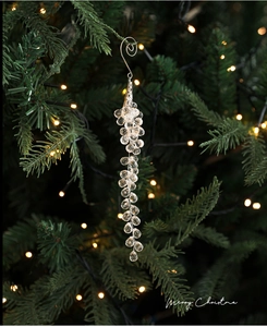 Macro shot of faceted crystal bead ornaments hanging on a Christmas tree with warm lights
