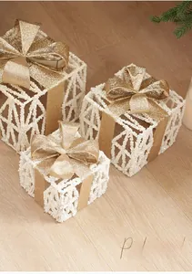 Three-piece set of white rattan Christmas gift boxes with gold glitter bows and pine cones