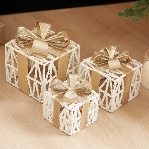 Three-piece set of white glitter gift box decorations with golden bows and pine cones
