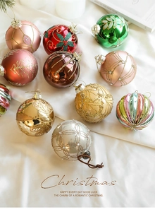 Close-up of 8cm colorful glass Christmas balls with gold glitter patterns and pearly beads