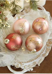 Detail of pink Christmas ball ornaments with gold glitter patterns and rhinestones