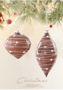 Detailed view of chocolate brown onion and teardrop Christmas ornaments with pearls