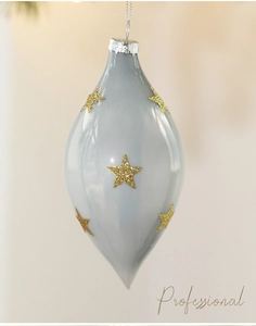 Close-up of a grey glass Christmas ornament with gold glitter stars and a silver cap