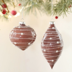Brown shiny glass Christmas balls with glitter spirals and pearls on a festive tree