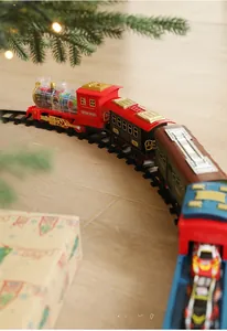 Close-up of retro electric Christmas train on track with festive holiday decorations
