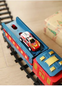 Close-up of vintage toy train carriage with mini racing car on Christmas tracks