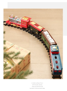 Macro shot of retro electric Christmas train on tracks with holiday gift box decor