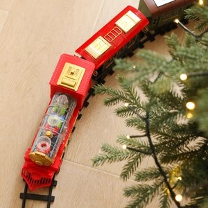 Electric Christmas train set with transparent engine and colorful gears on wooden floor