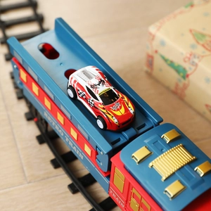 Electric retro train toy set with race car on track for Christmas holiday decoration