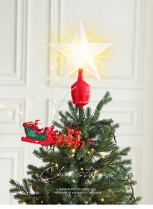Rotating Christmas tree topper with glowing star and flying Santa reindeer sleigh detail