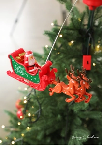 Rotating Santa Claus and reindeer sleigh Christmas tree topper with festive light background