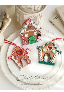 Detailed view of three festive gingerbread house ornaments with colorful candy decorations