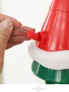 Close-up of the power connector on a rotating Christmas tree topper with waved texture
