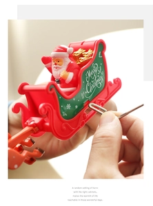 Close-up of rotating Christmas tree topper with Santa in a red sleigh and Merry Christmas text