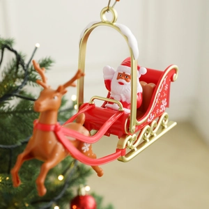 Rotating Santa and reindeer tree topper on a Christmas tree with festive lights
