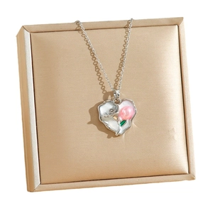 Vintage heart necklace with freshwater pearl background and floral pendant design