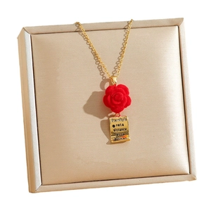 Elegance red rose pendant necklace with gold engraved tag on jewelry box