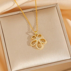 Golden titanium steel necklace with micro-pave zircon flower pendant on jewelry box