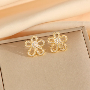 Golden flower earrings with micro-set cubic zirconia petals on champagne satin fabric