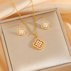 Elegant gold pearl jewelry set featuring honeycomb zircon flower necklace and earrings