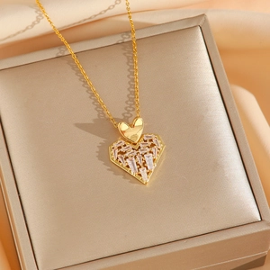 Luxury gold heart pendant necklace with shimmering zircon inlay on elegant jewelry box