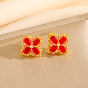 Elegant four-leaf clover flower earrings with red oval gemstones and gold plating