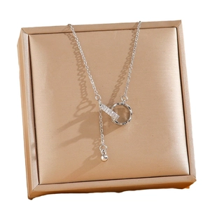 Silver geometric necklace featuring a pavé zircon bar and dual ring pendant design