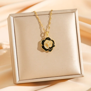 Vintage camellia necklace with black petals and sparkling crystals on gold-tone chain